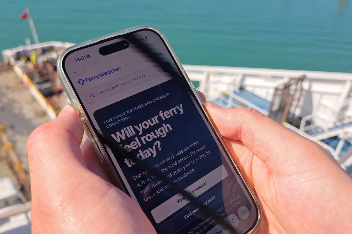 Passenger checking FerryWeather during a ferry crossing